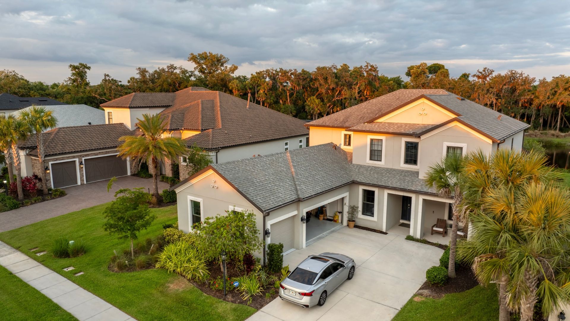 Luxury Home in a Florida Residential Community residential home with landscaped yard and neighboring luxury properties.
