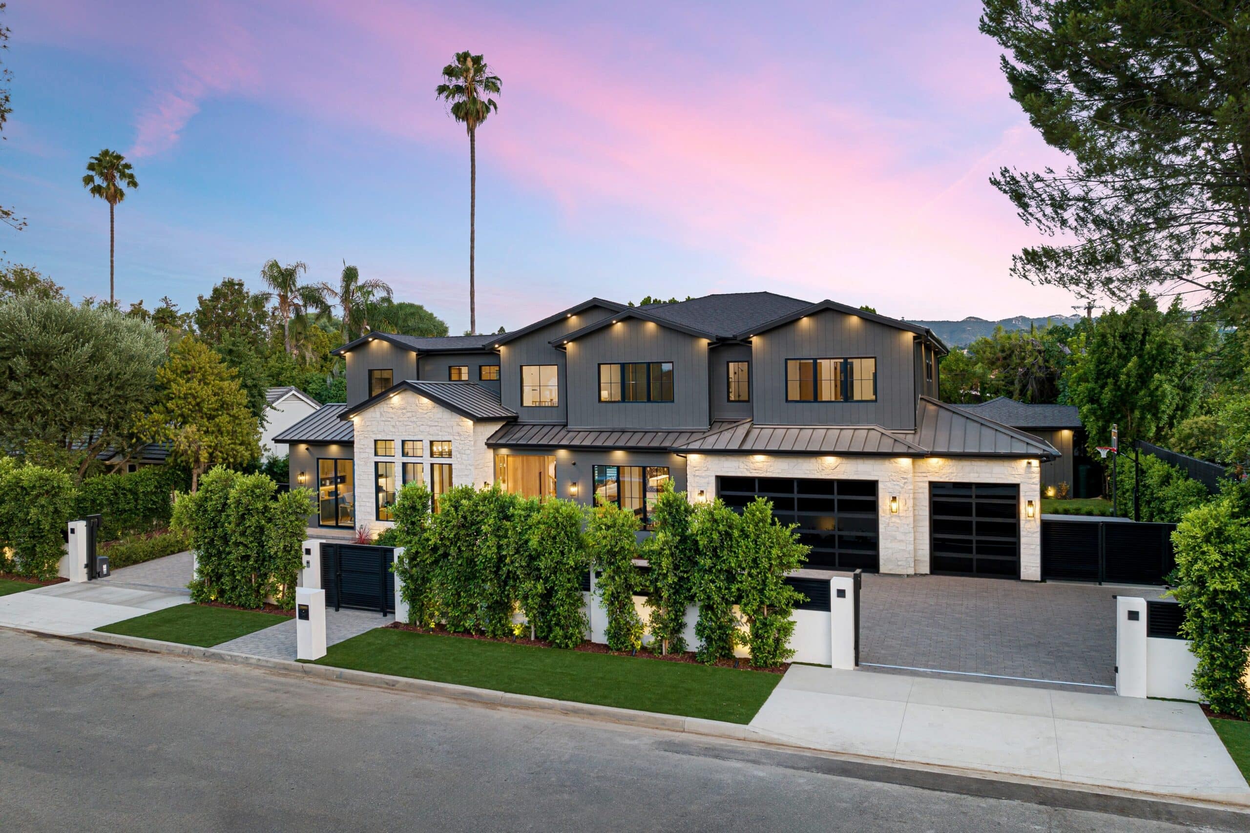 Beautiful Luxury Home With Exceptional Curb Appeal Luxury modern home with gated entrance, landscaped front yard, and contemporary architecture at sunset.